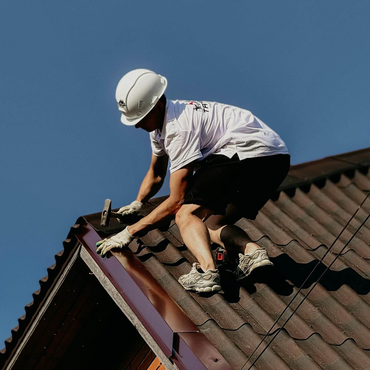 Roofer working on a metal roof